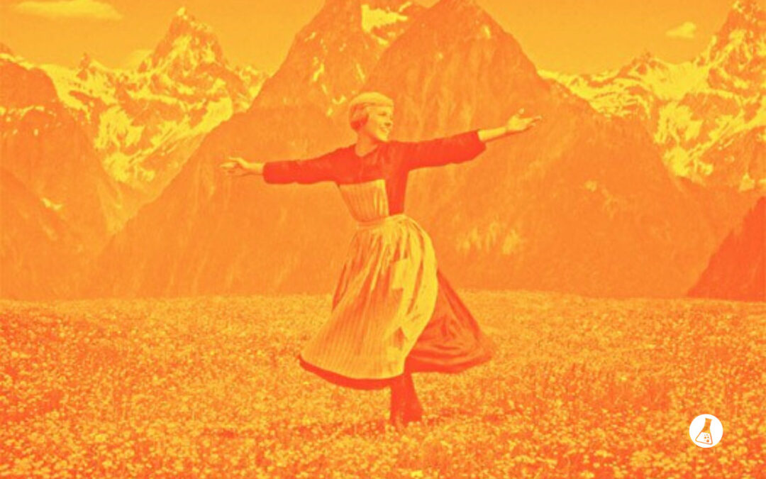 woman in mountains arms outstretched Kickstartology